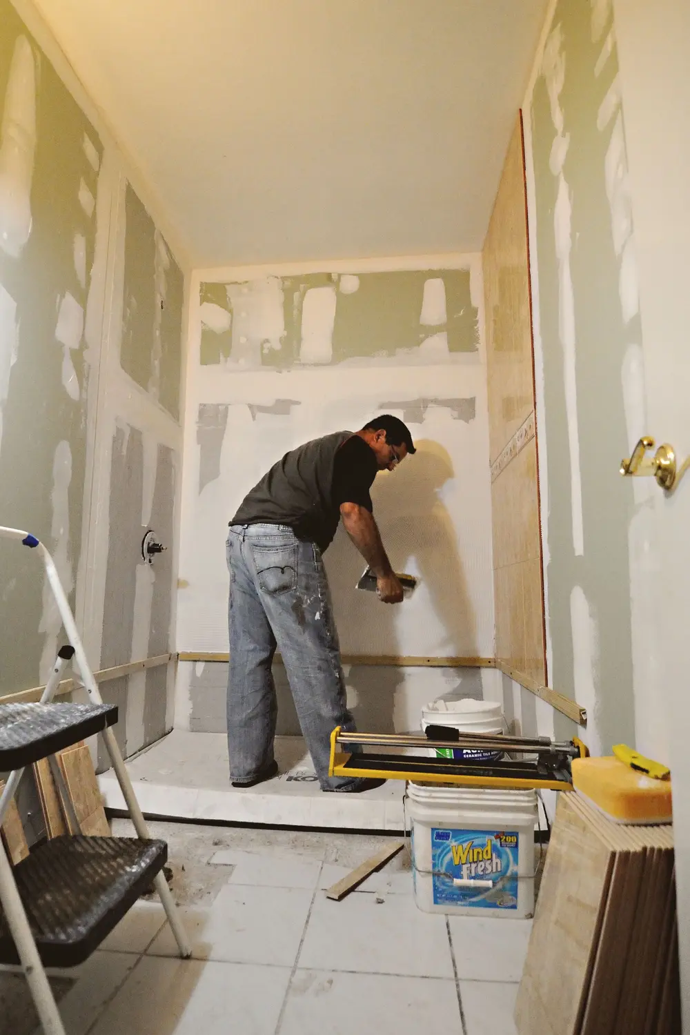 Installer hanging new drywall in a bathroom remodel
