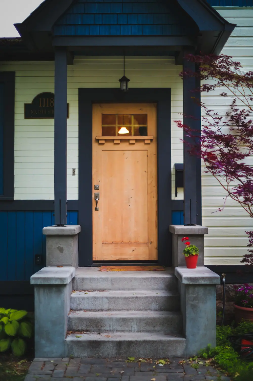 Craftsman-style front door and porch steps on an older home